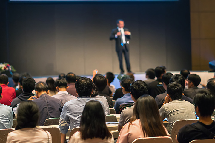 Event Photography | rear-side-of-audiences-sitting-and-listening-the-s-7RKKEH2.jpg
